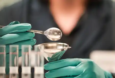photo of a Bayport researcher experimenting with chemicals and test tubes