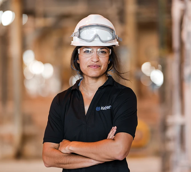 Plant worker in a hard hat representing quality and safety standards in manufacturing