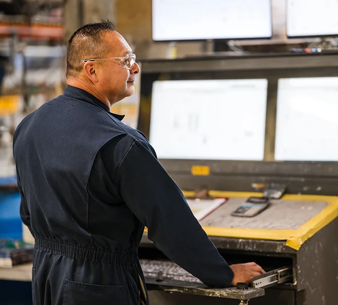 Plant operator at a controle console supporting safe and controlled operations